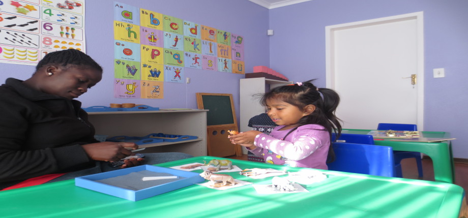 Kid and teacher playing